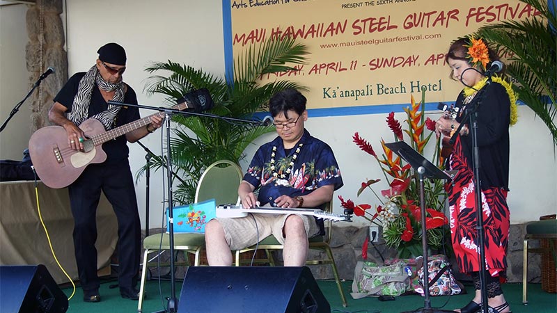 Gary Aiko, Shinichi, and Kumiko performing on the 2014 Maui Steel Guitar Festival Open Stage